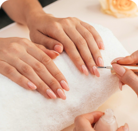 Close-up of professional nail care service with neatly manicured hands.