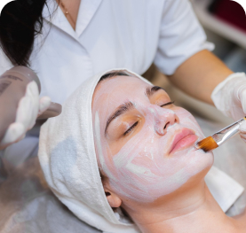 Woman receiving a professional facial treatment at a skincare clinic