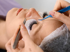 A close-up image showcasing beautifully extended eyelashes with a natural, voluminous look.