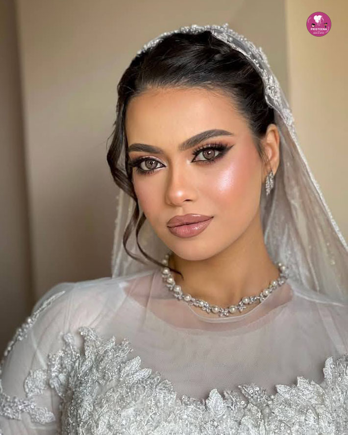 Arabic bride in Dubai wearing traditional gold-embroidered bridal gown with headpiece and glam makeup