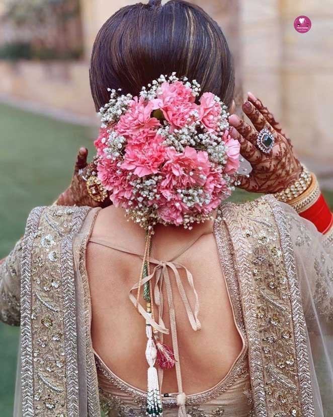 Elegant bride showcasing the best bridal hairstyle with soft curls and floral accents.