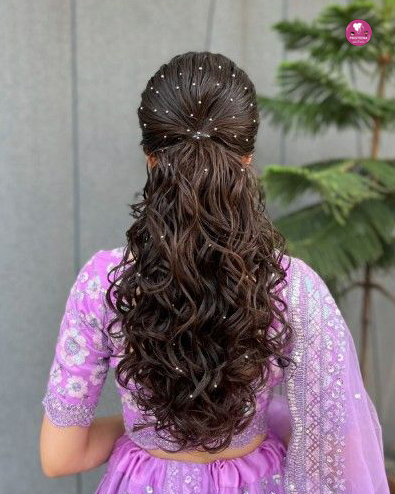 Woman with glamorous curls styled for a party, showcasing the best party hairstyle in Dubai.