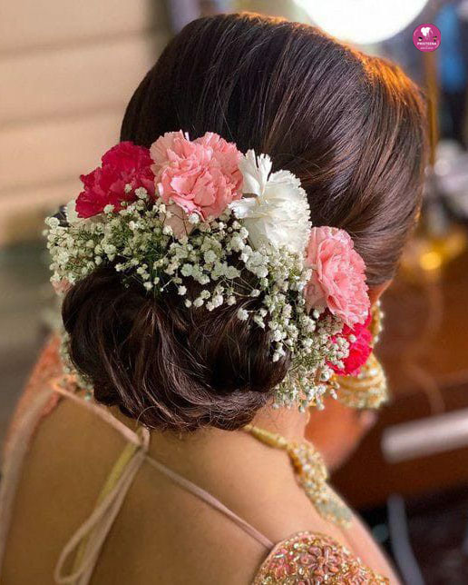 Elegant bridal hairstyle in Dubai featuring soft curls and traditional accessories.