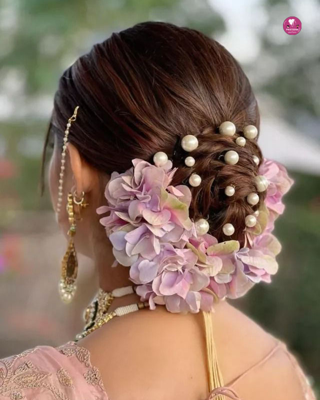 Elegant bridal hairstyle with soft curls and floral hair accessories.