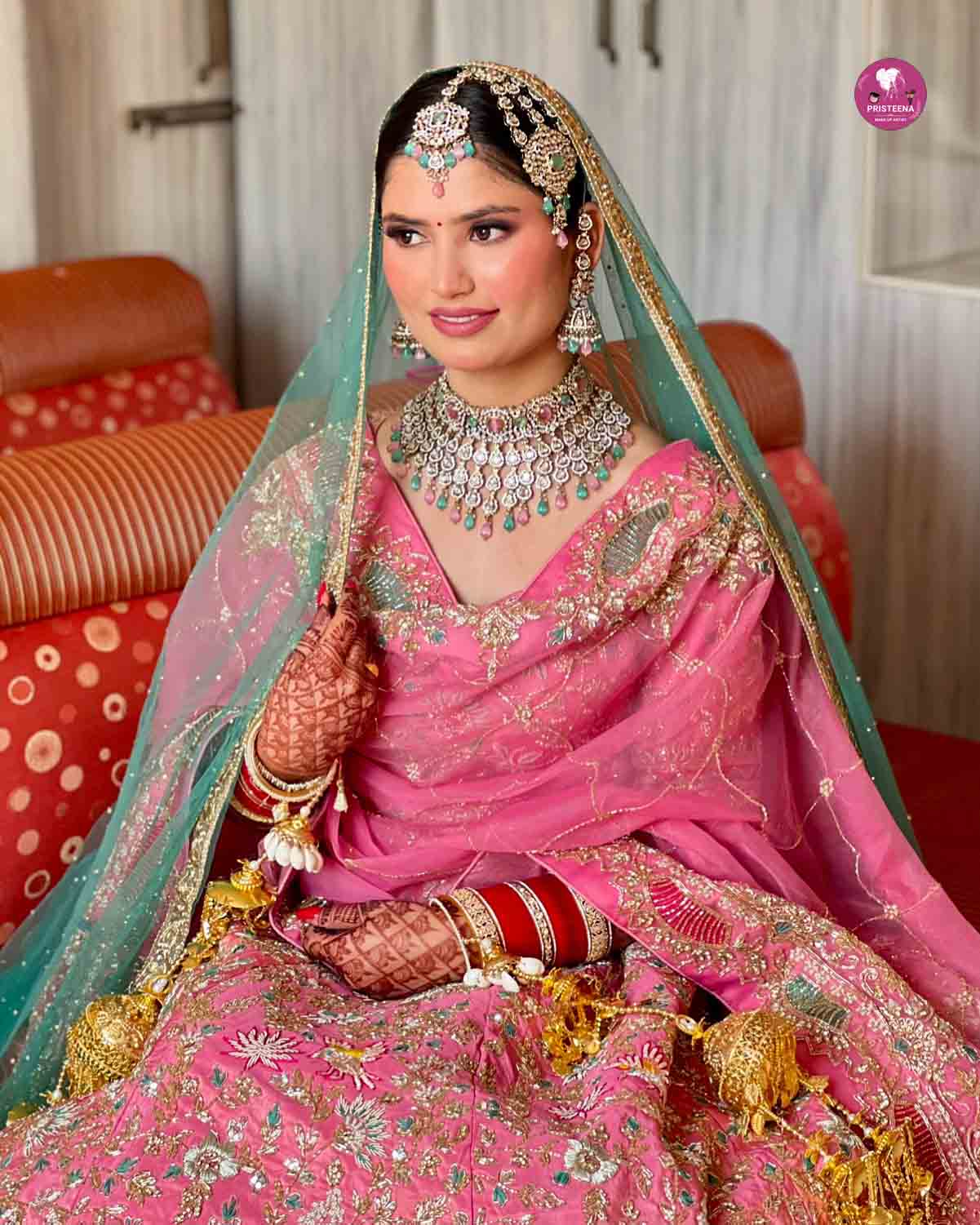 A professional bridal makeup artist in Dubai applying elegant makeup to a bride on her wedding day.