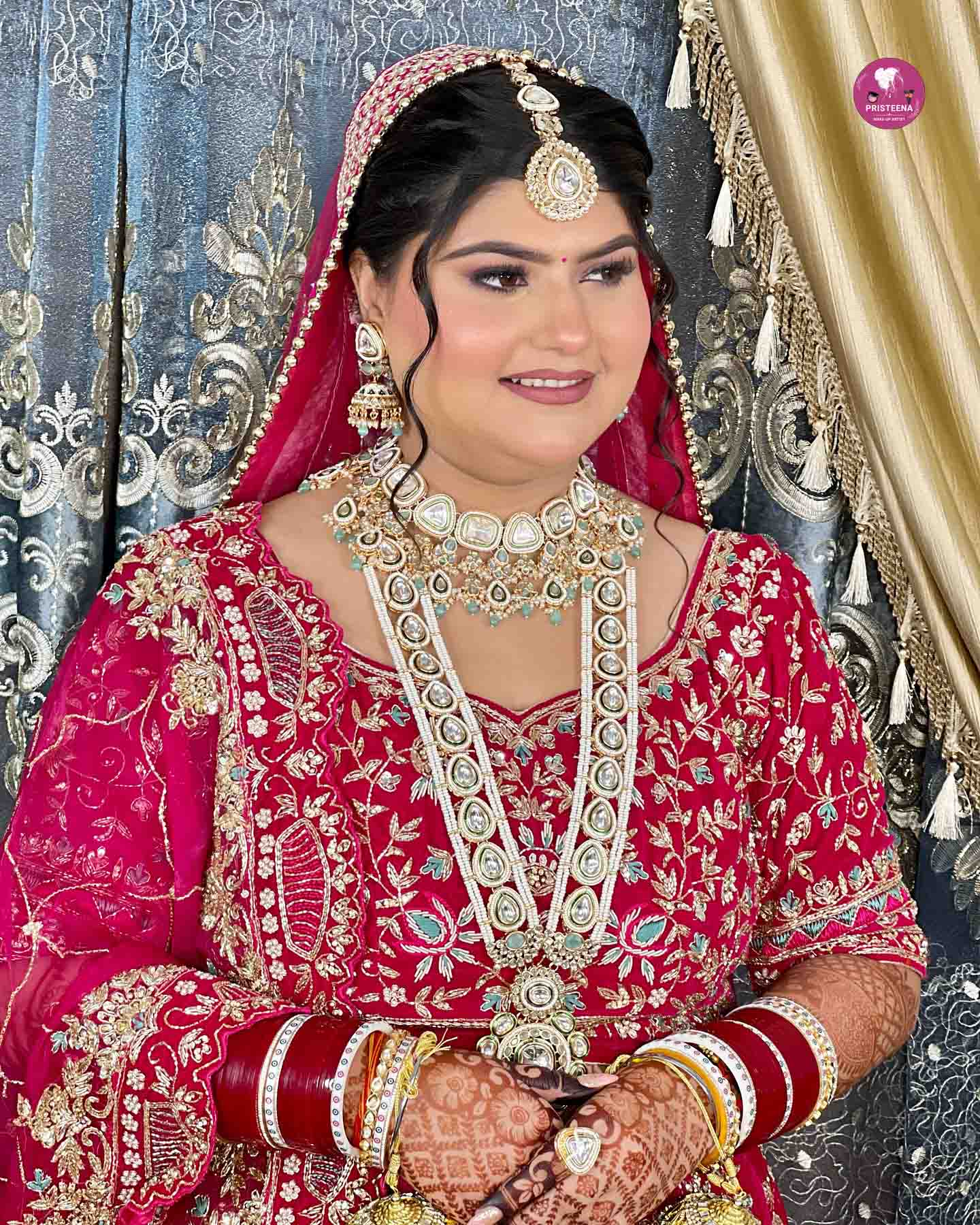 A stunning Indian bride in traditional attire with flawless bridal makeup in the UAE, showcasing vibrant colors and intricate detailing.