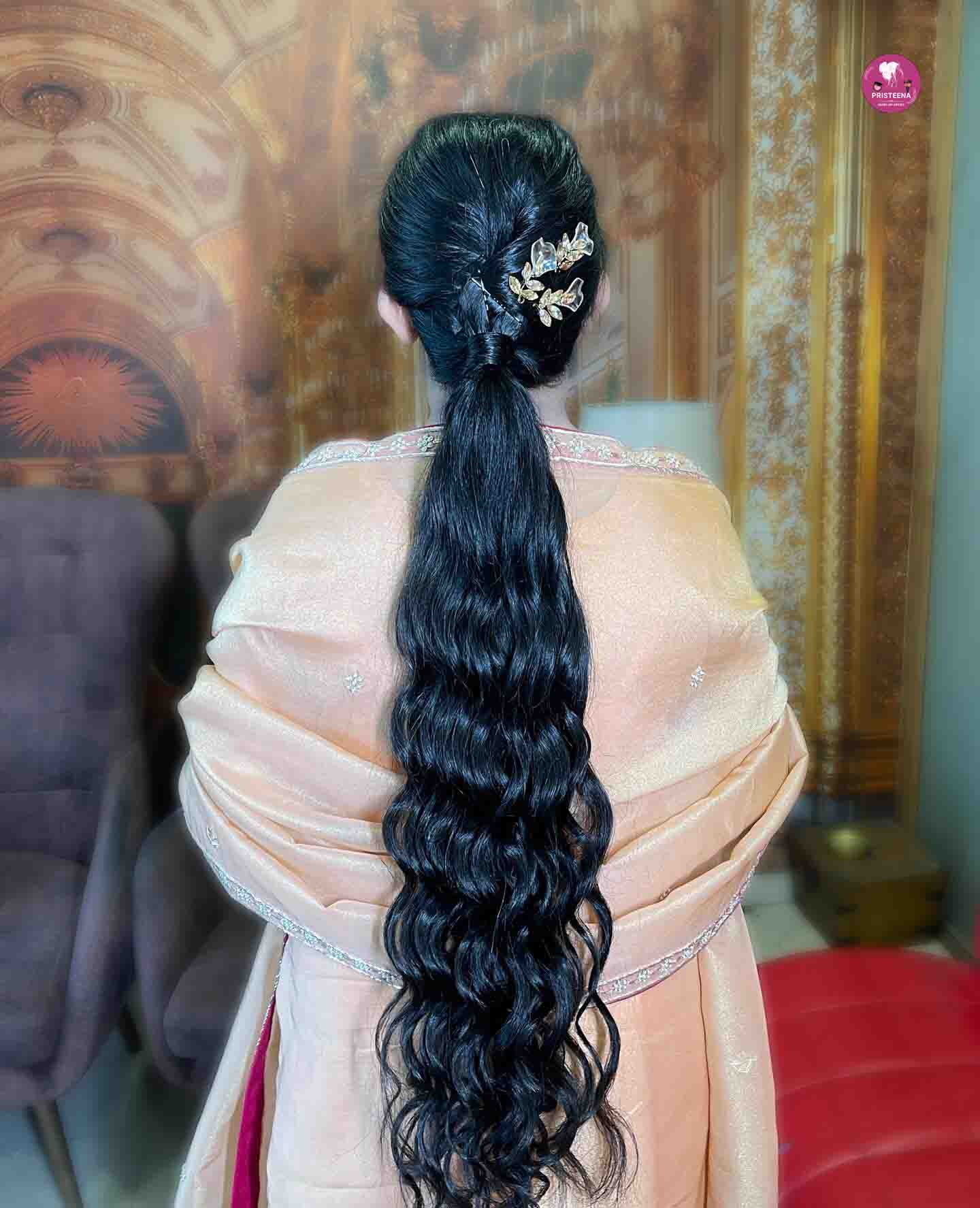 Traditional North Indian hairstyle featuring intricate braids and floral embellishments, perfect for weddings and festive occasions.