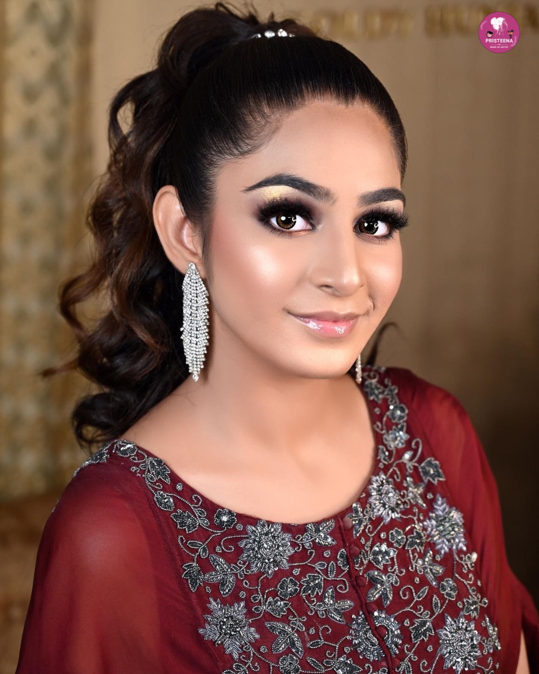 A professional makeup artist applying glamorous party makeup to a woman in Abu Dhabi salon.
