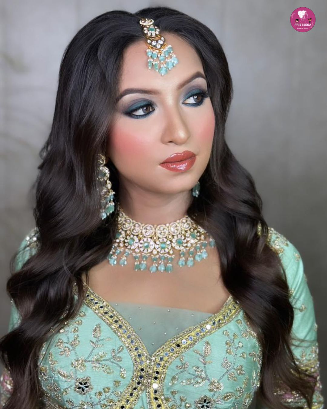 A professional makeup artist applying glamorous party makeup to a woman in a beauty studio in Sharjah.