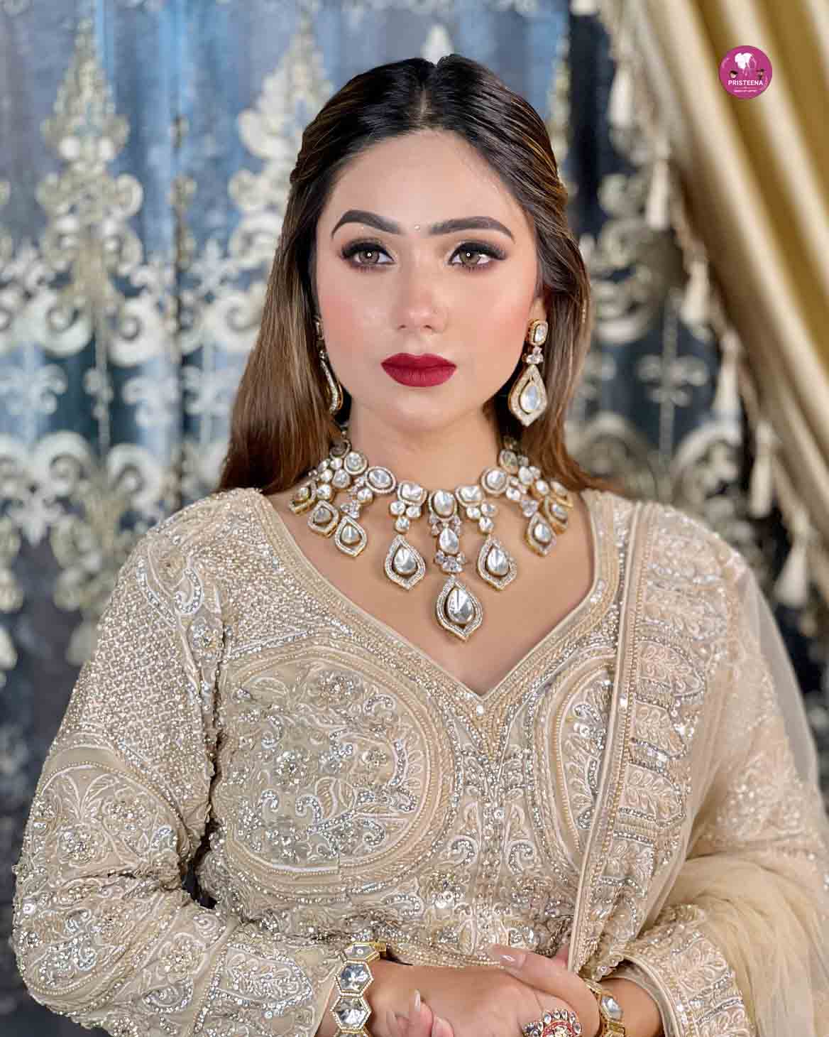 Woman with glamorous party makeup featuring bold eyeshadow, defined brows, and glossy lips.
