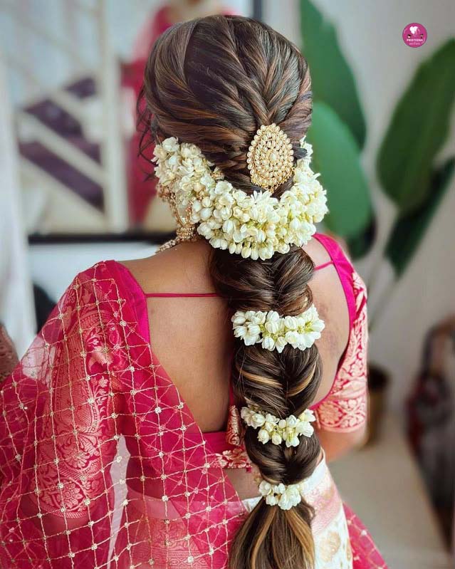 Traditional South Indian bridal hairstyle with flowers in Dubai salon
