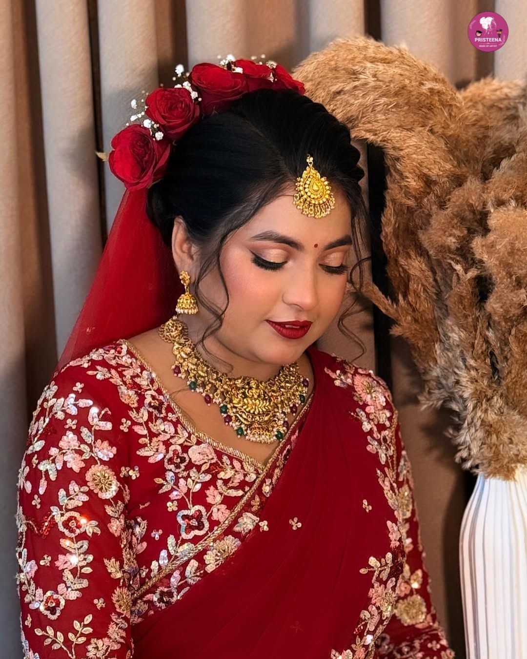 Bride getting her makeup done by a professional wedding makeup artist in Dubai, featuring elegant bridal glam and traditional accessories.