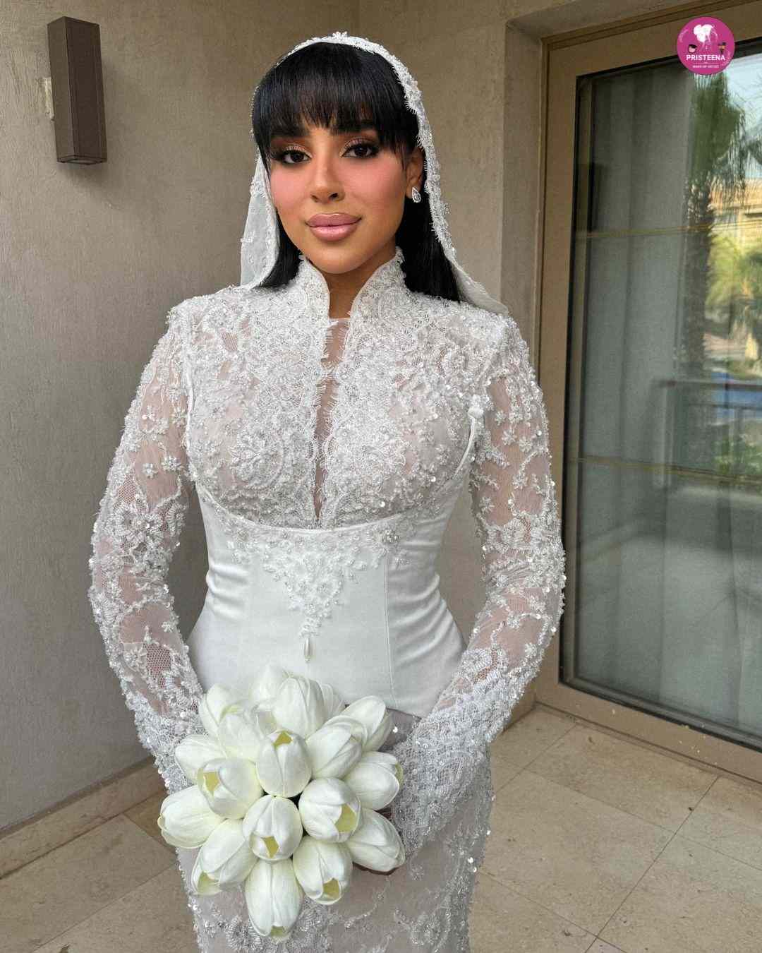 Asian bridal makeup artist in Dubai applying traditional bridal look on bride