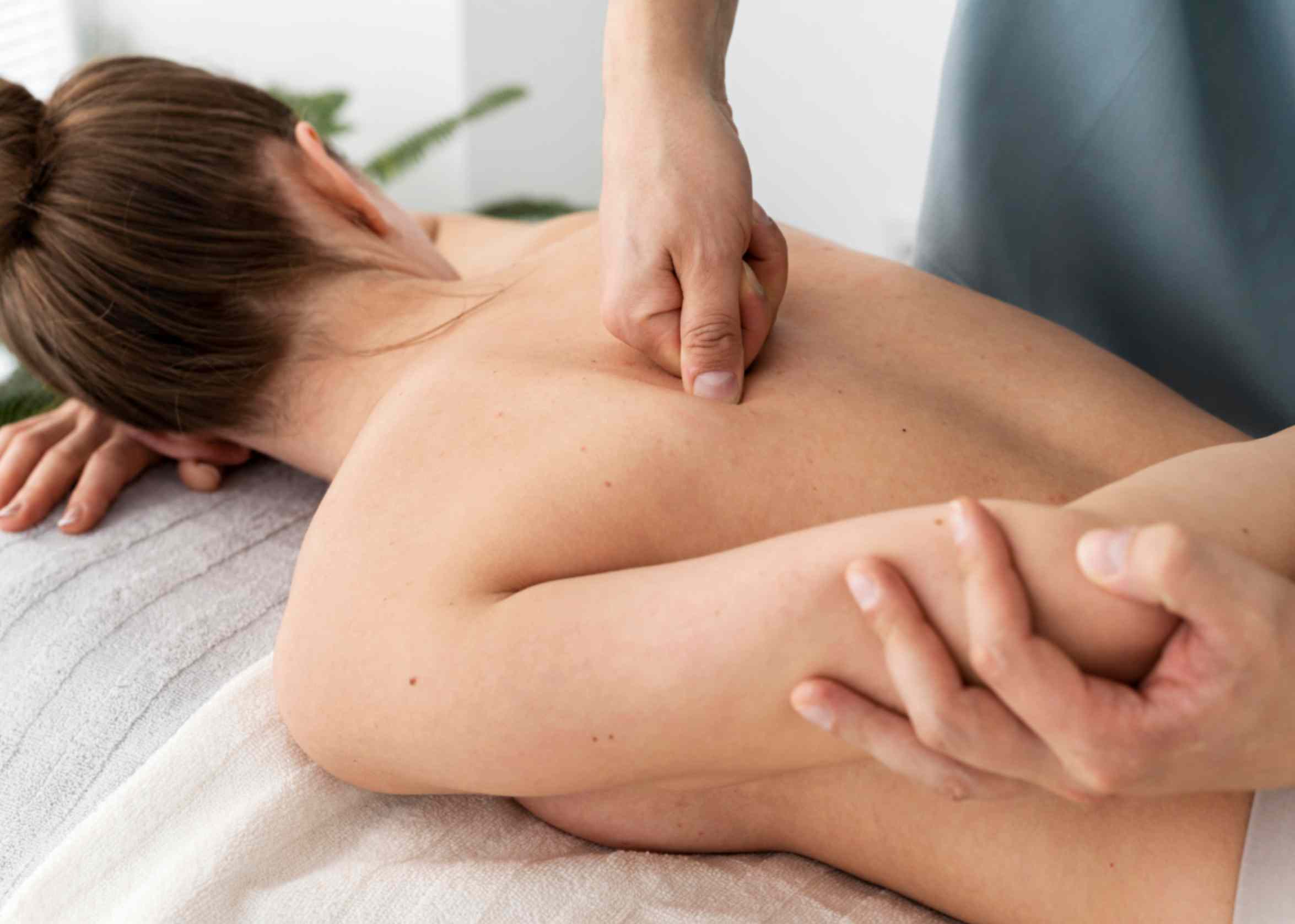 a female client getting deep tissue massage in dubai