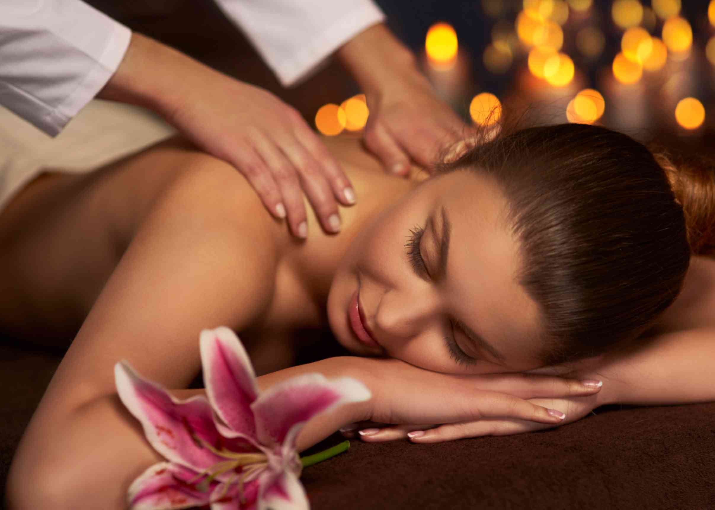 a lady enjoying a full-body relaxation massage at home in Dubai